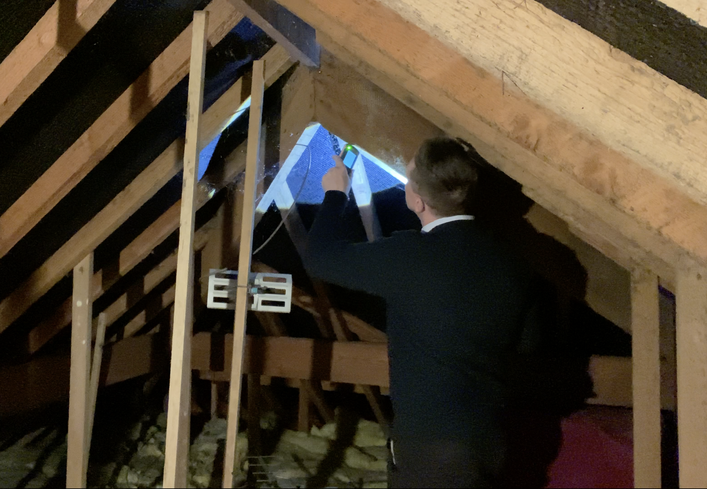 Andrew Raynor, director at Fylde Coast Chartered Surveyors, inspecting the roof in an attic